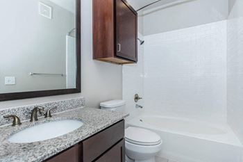 a bathroom with a sink toilet and a mirror